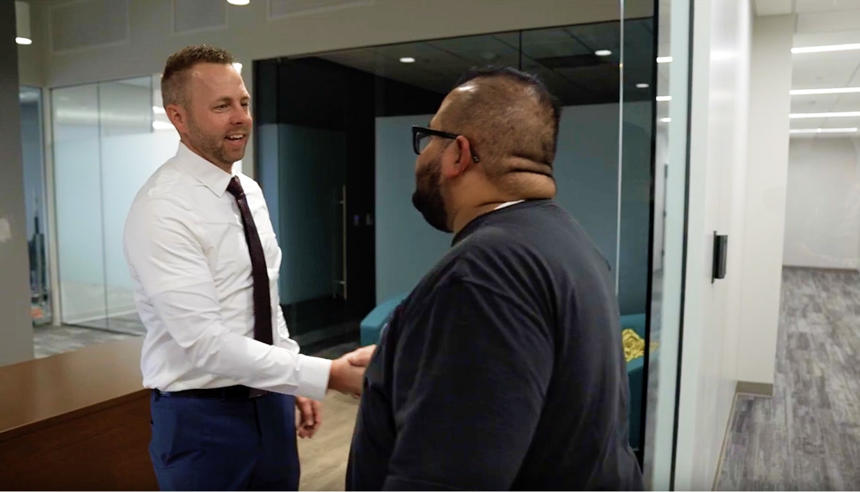 Attorney Ashton Hyde shaking hands with a client