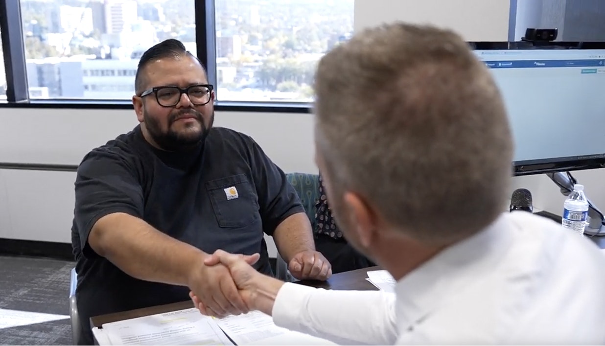 client shaking hands with attorney