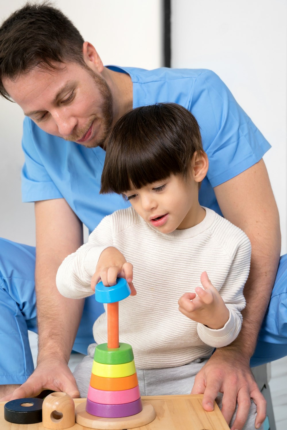 Father with young son engaging in therapy
