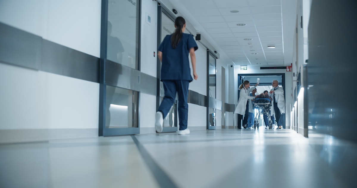 Medical professionals walking through a hospital corridor