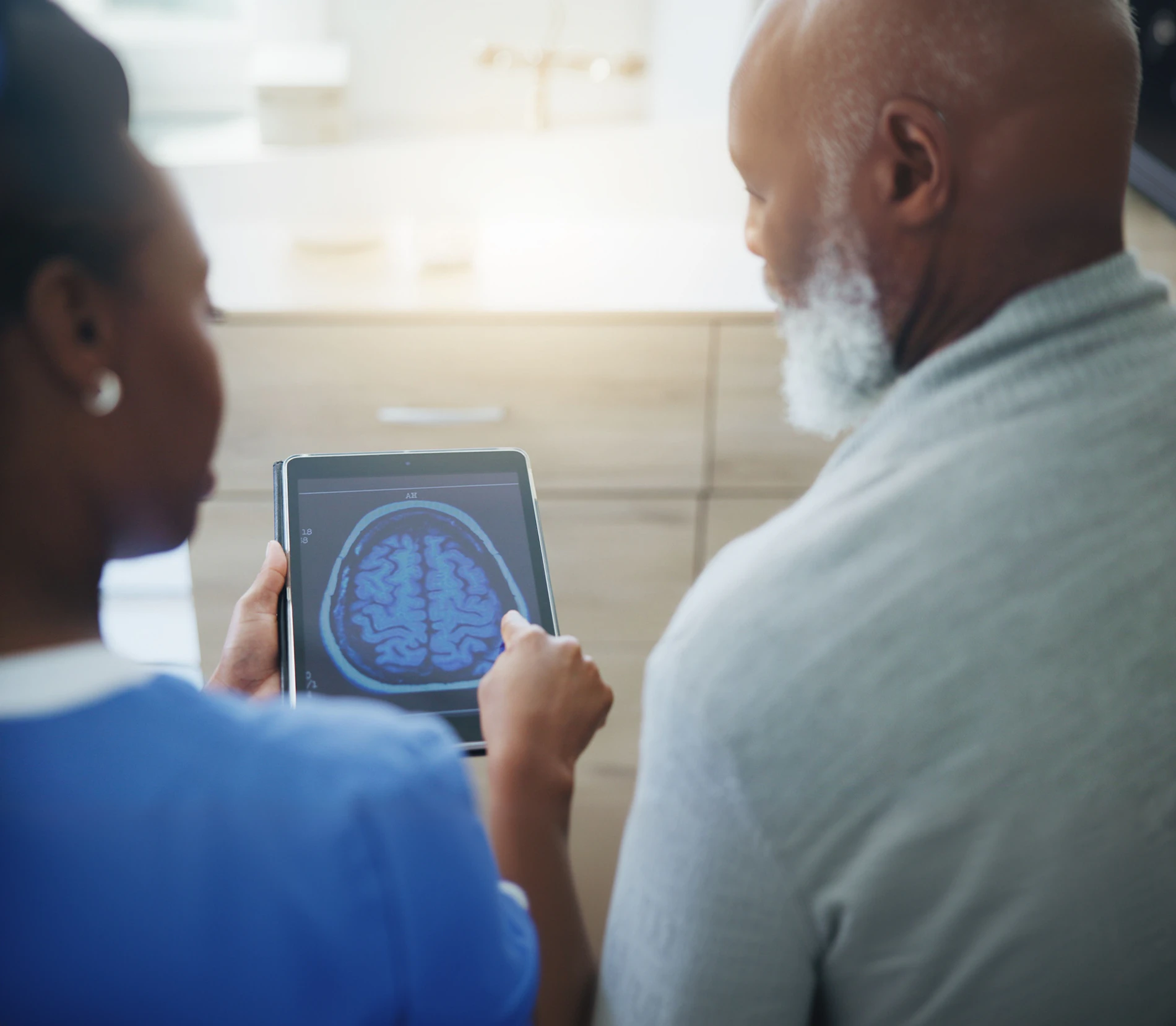 Patient and medical professional looking at a brain scan