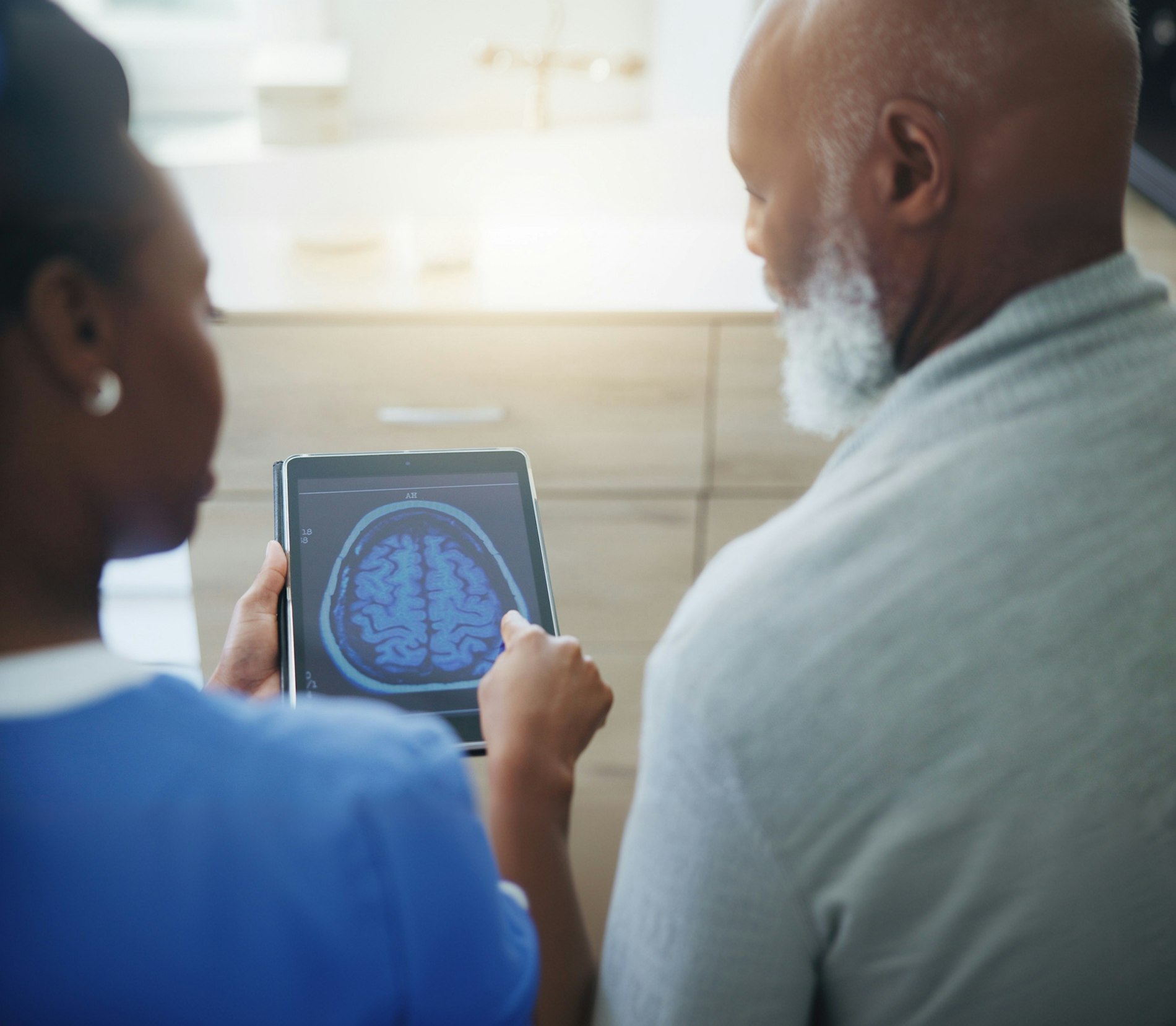 Patient and medical professional looking at a brain scan