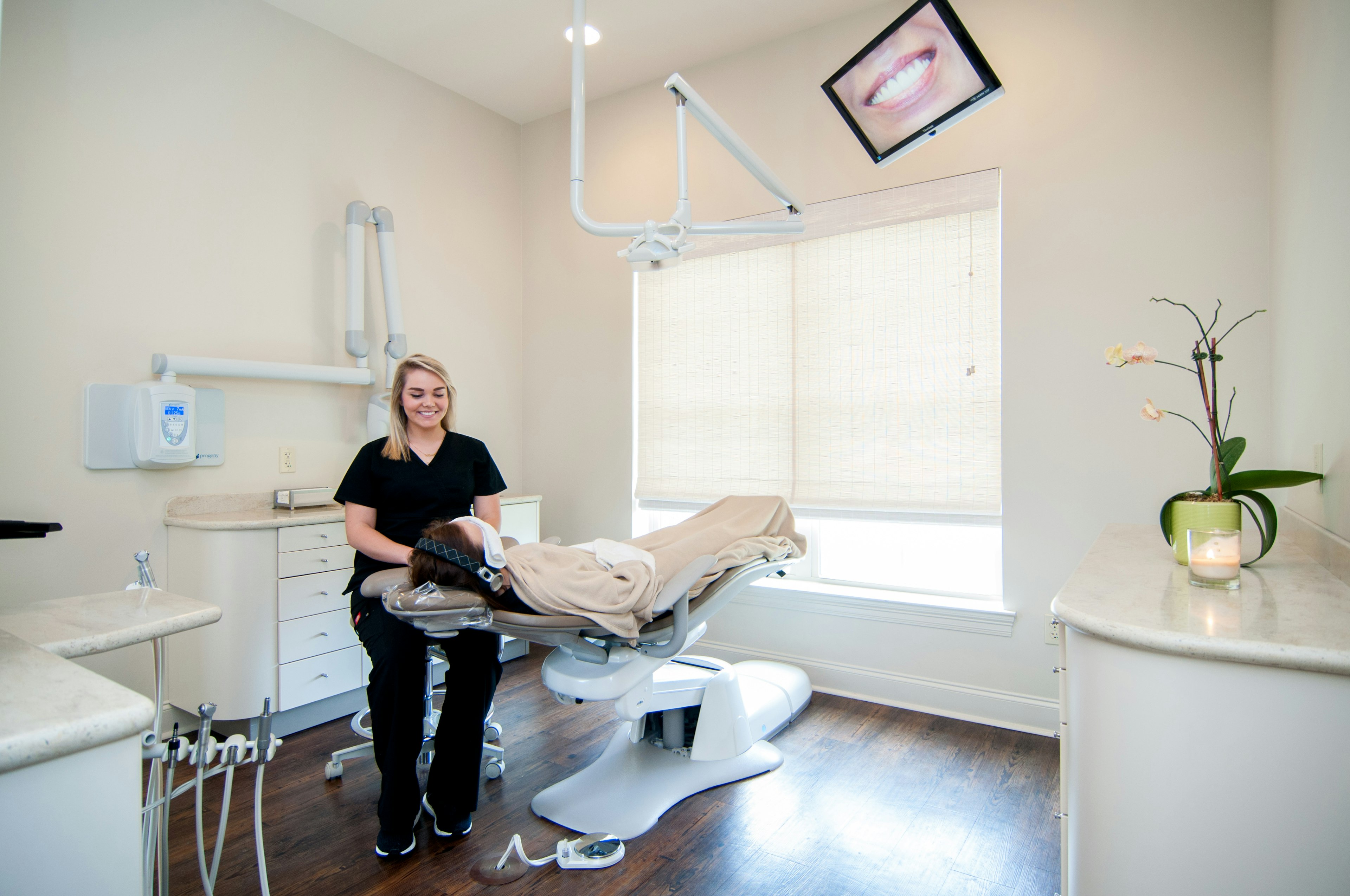 Staff providing warm blankets, heated neck wraps, headset, and eye masks for patient