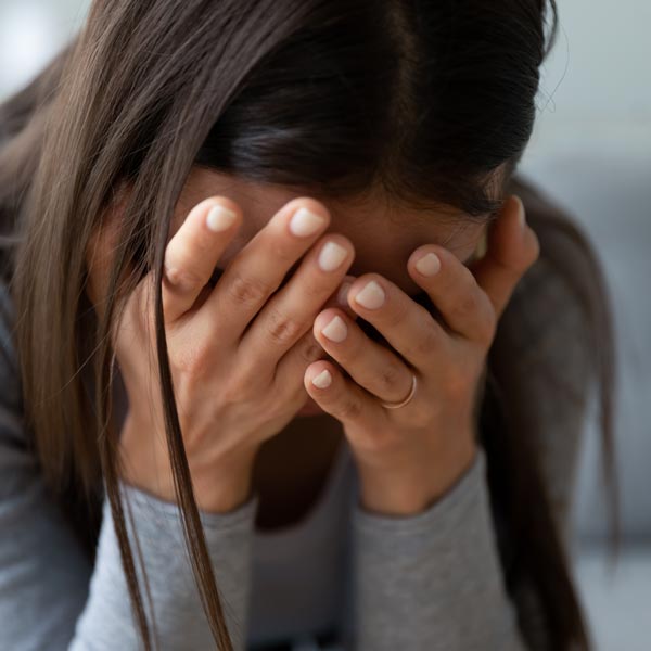 Woman Crying with Face in Hands