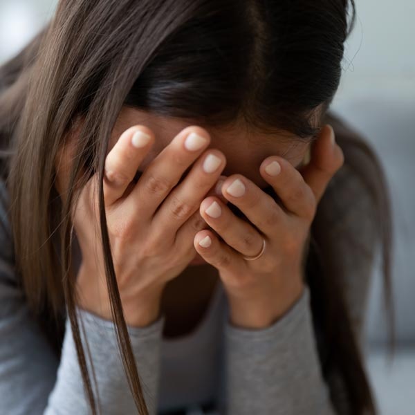 Woman Crying with Face in Hands