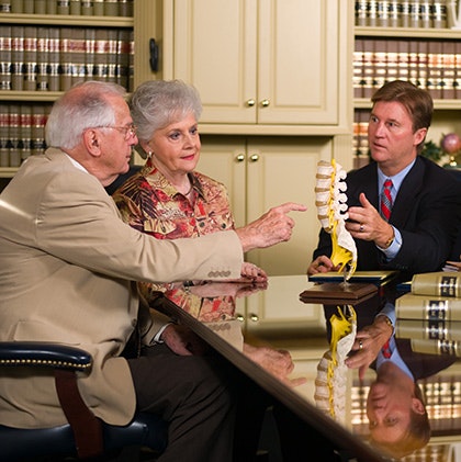 Daniel D. Moody having a consultation with an elderly couple