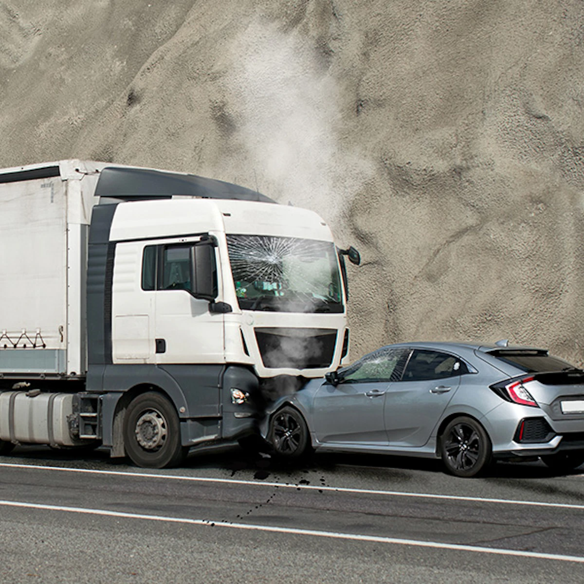 A semi-truck and passenger car collision on a highway