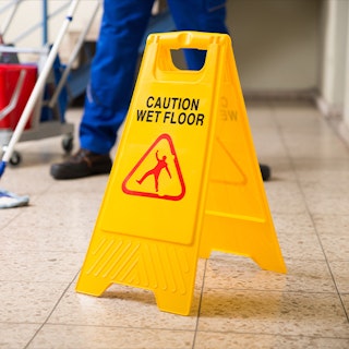 wet floor sign near janitor