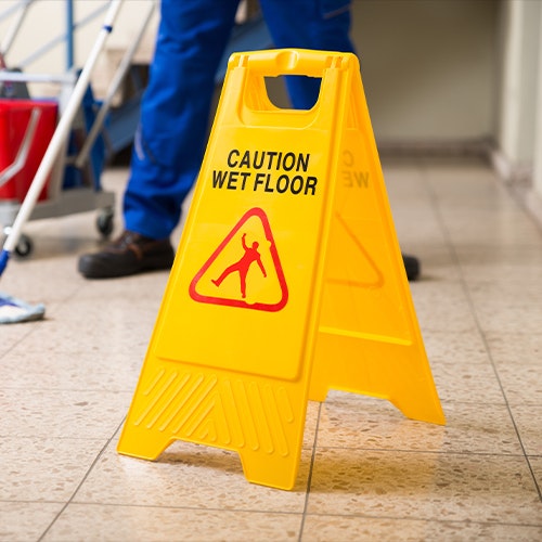 wet floor sign near janitor