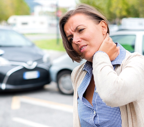 woman holding neck in pain after car accident
