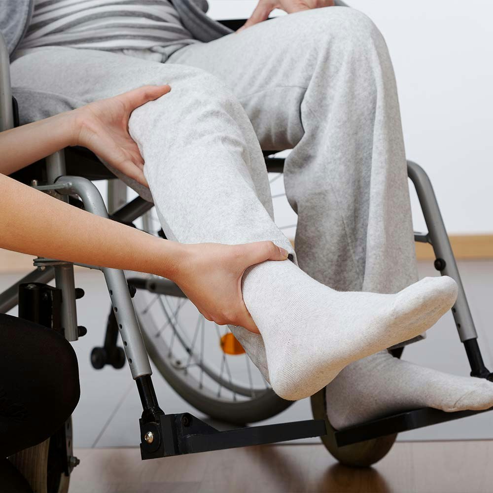 Person Holding Leg in Cast and Wheelchair