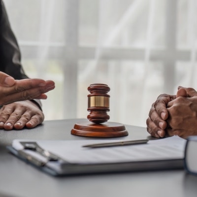 lawyer and client having a conversion beside a gavel