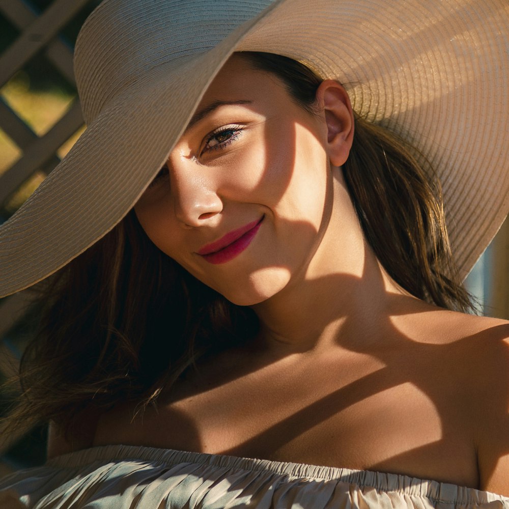 Woman with sun hat sitting in shade