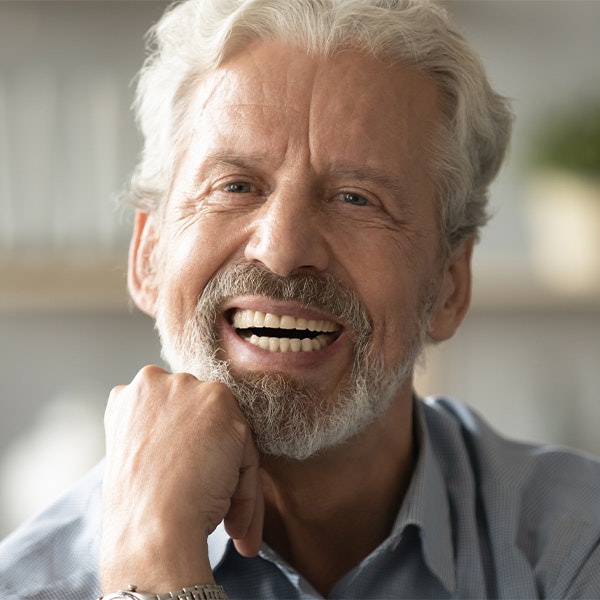 mature man with dentures smiling