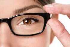 Optician holding a pair of glasses