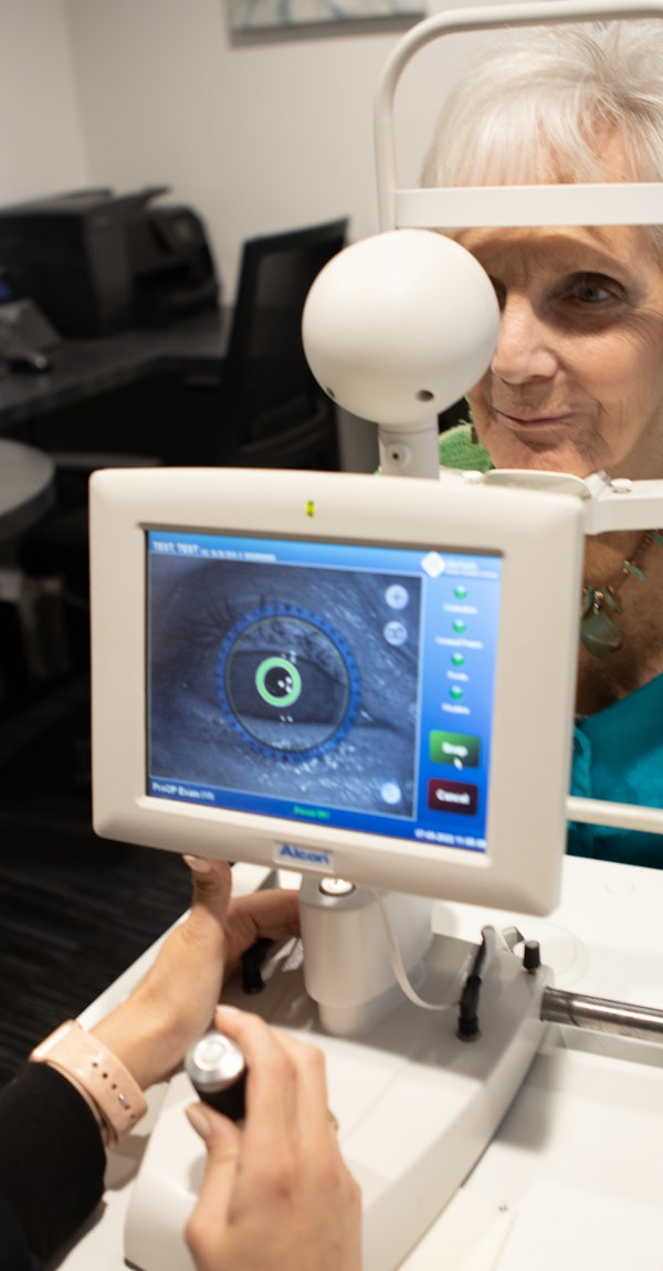 Woman undergoing eye exam using advanced technology