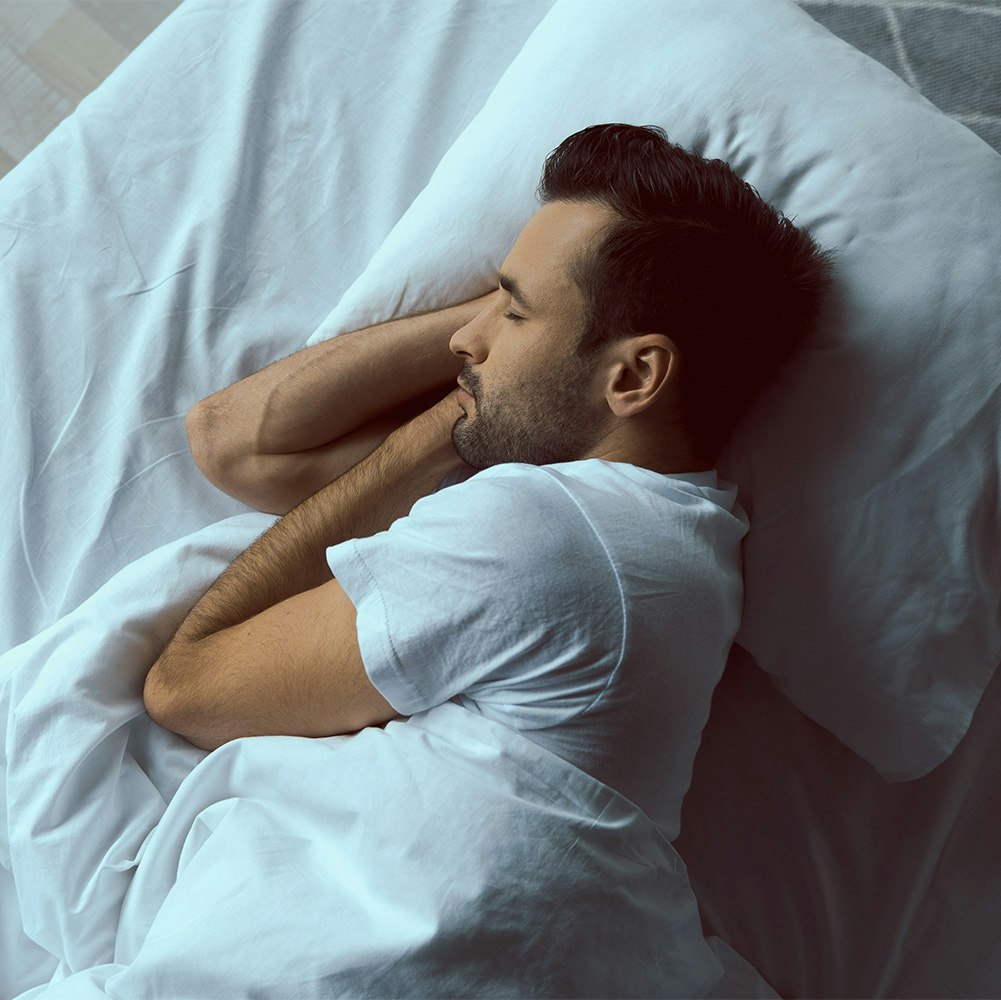 Man sleeping peacefully in bed