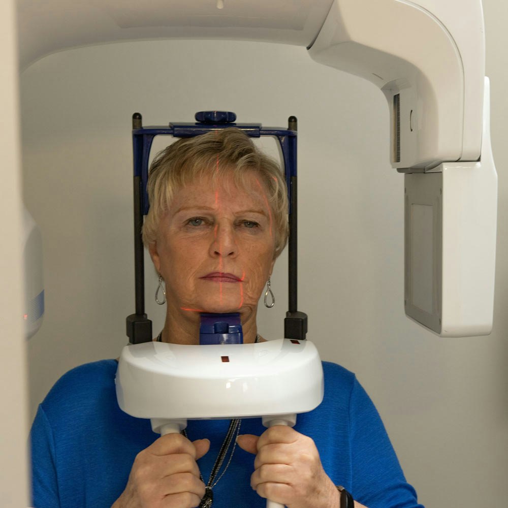 Patient getting x-ray scans through CT scan