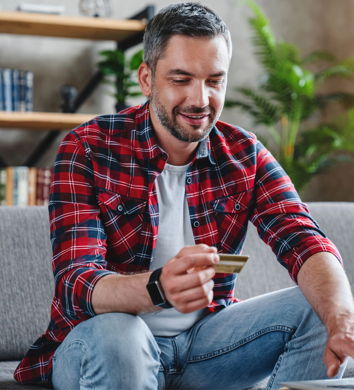 man looking at his credit card