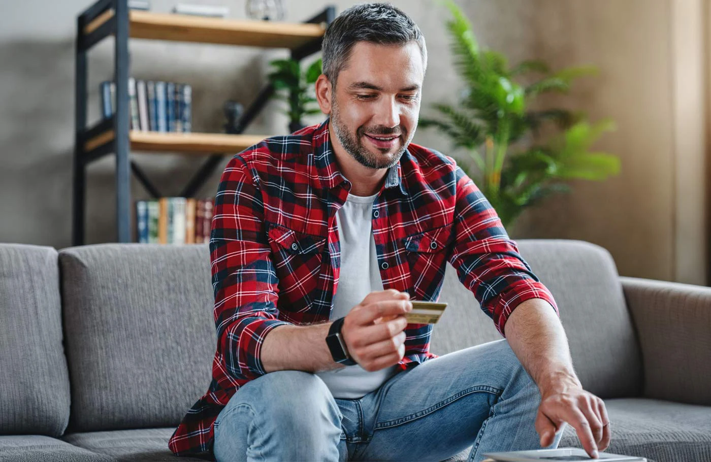 guy smiling holding credit card