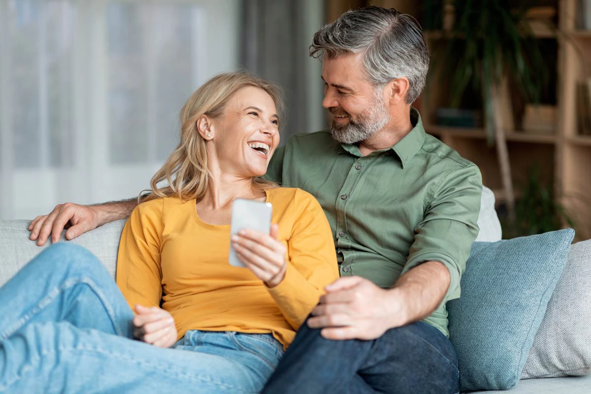 Older couple of phone smiling