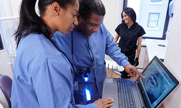 Dr. Stanislaus and Dr. Reid at computer