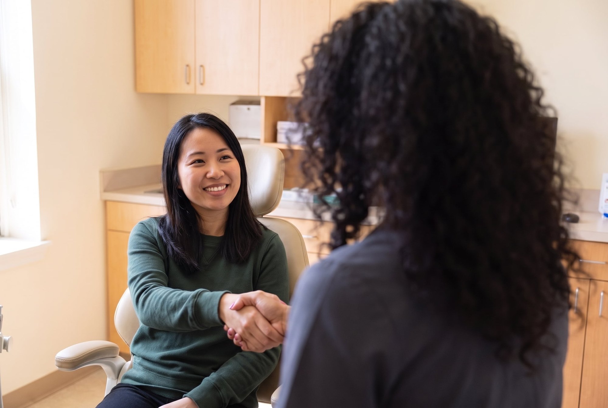 Brooklyn Heights Dental dentist greeting a patient with a handshake