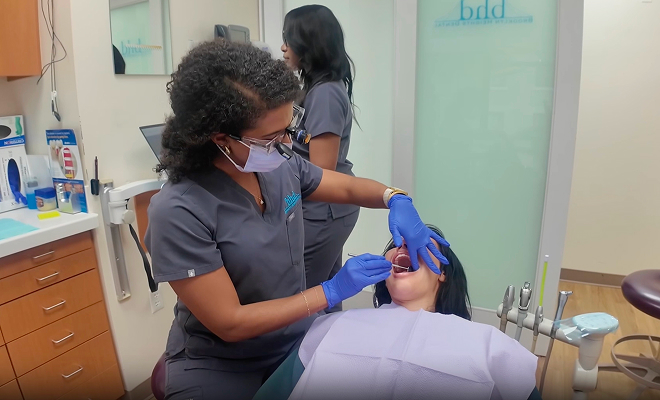 Brooklyn Heights Dental dentist and assistant treating a patient