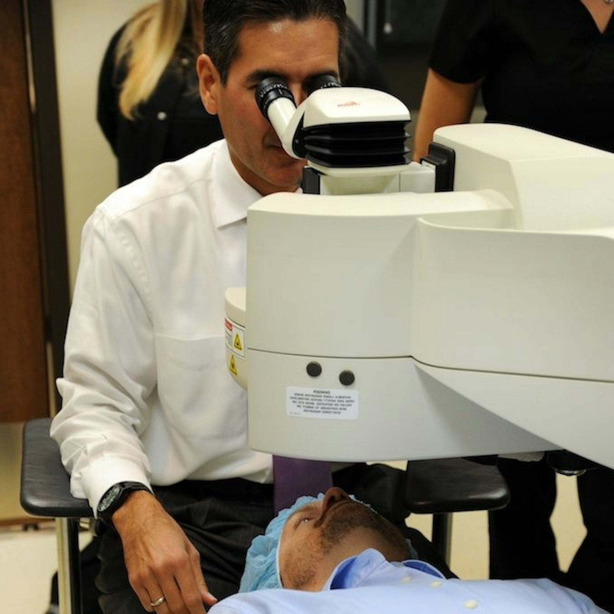 Doctor reviewing laser machine