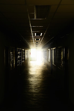A dark, poorly lit walkway