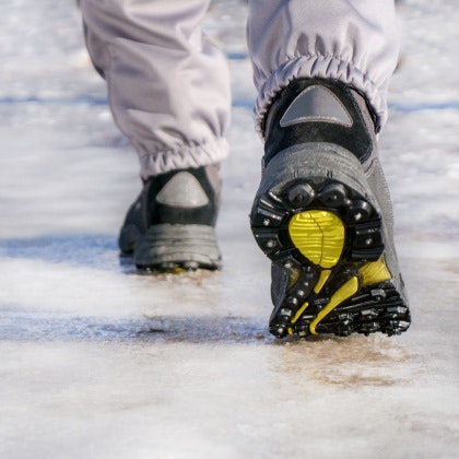 Person walking along an icy sidewalk