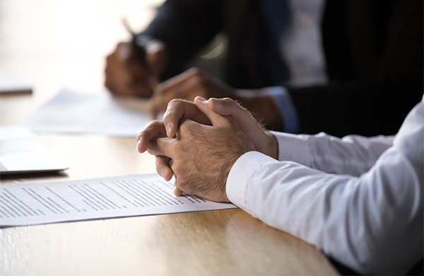 Two men discussing paperwork