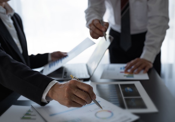 Two men discussing paperwork
