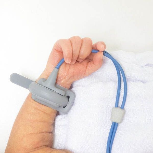 a baby's arm with a monitoring device strapped to the wrist