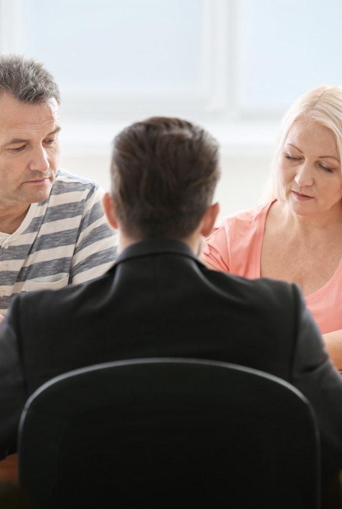 Couple talking with lawyer
