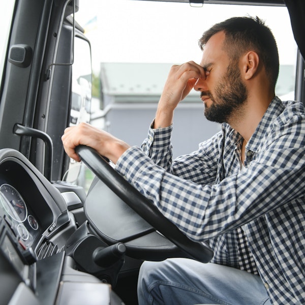 Driver with head in hands