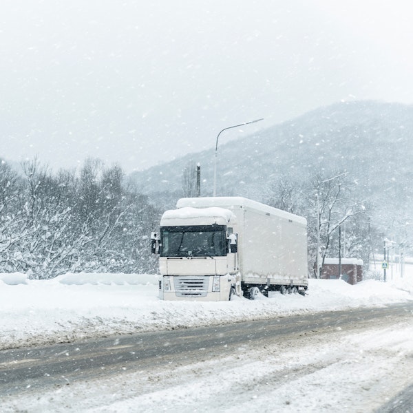 Truck driving through thick snow