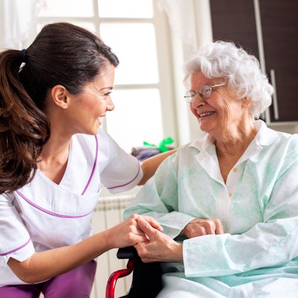 nurse attending to an elderly woman
