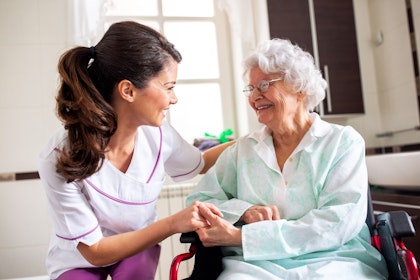 nurse attending to an elderly woman