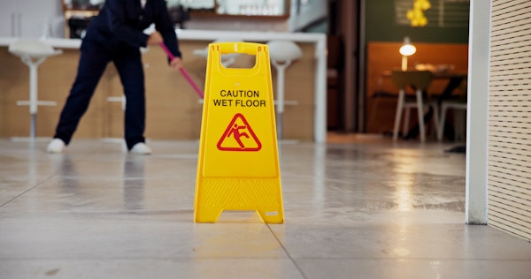 Caution wet floor sign on a wet office building floor