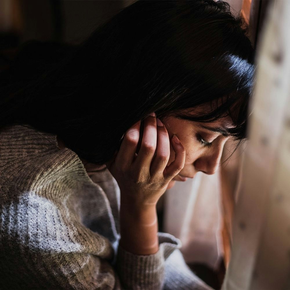 Sad and worried woman suffering from PCOS