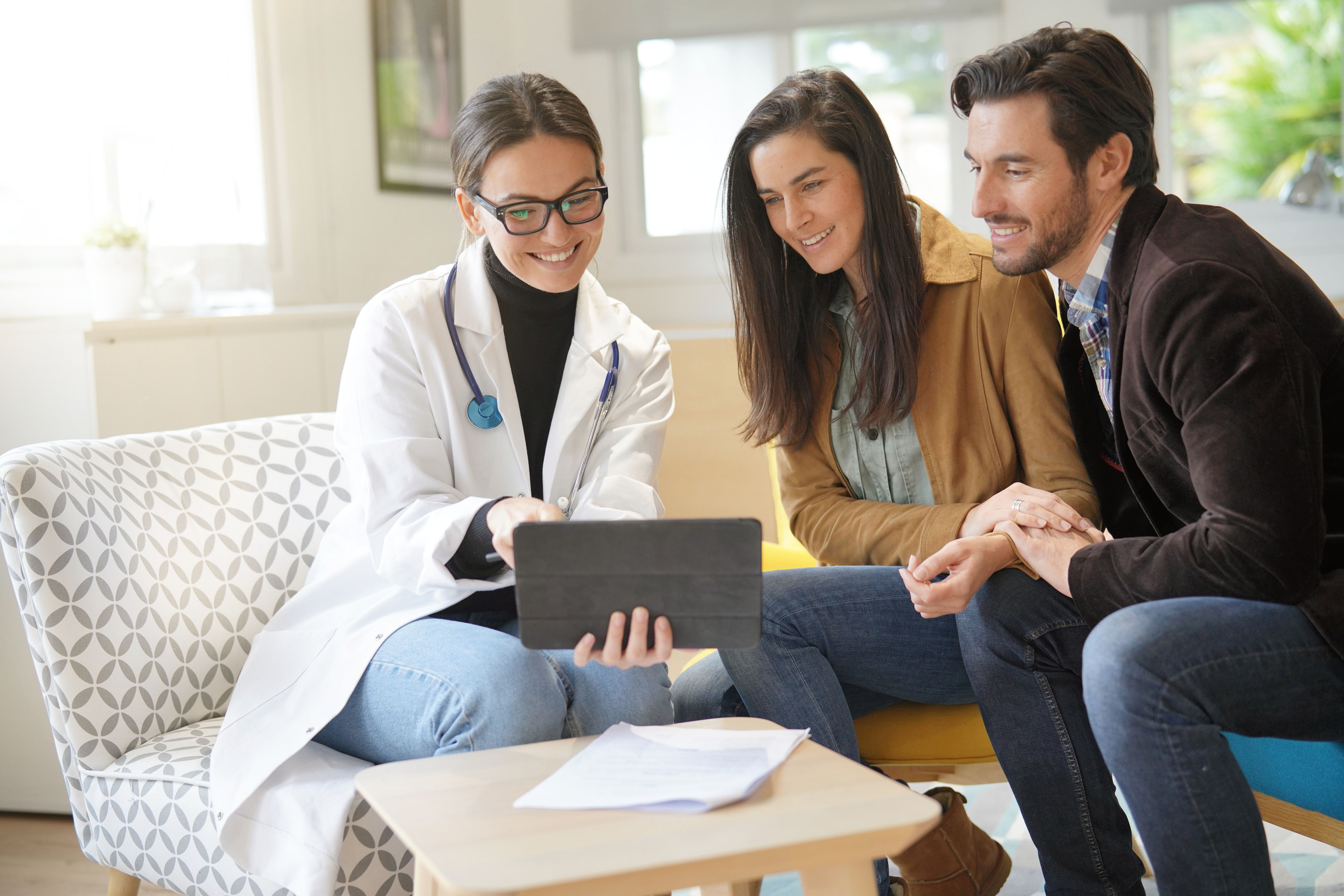 Smiling doctor with couple