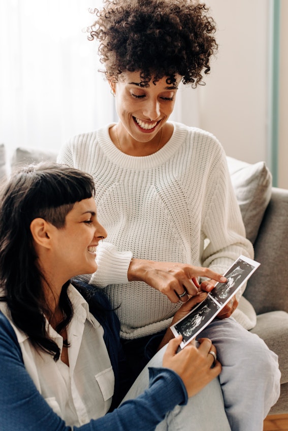 lesbian couple looking at pregnancy ultrasound