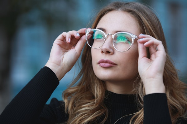 Woman trying on glasses.