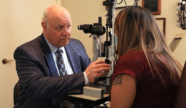 Dr. Del Piero examining a patient's eye