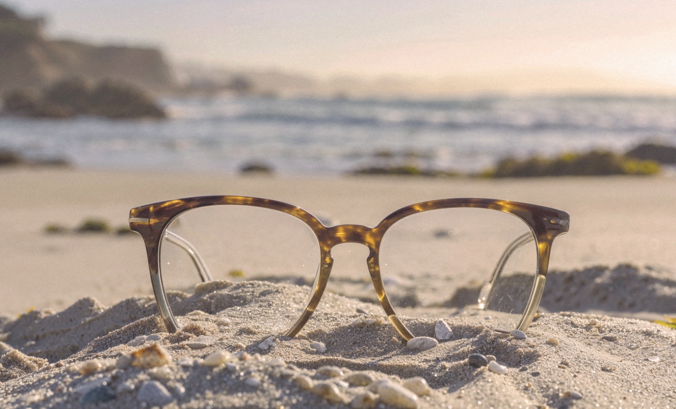 a pair of glasses on the monterey coast sand