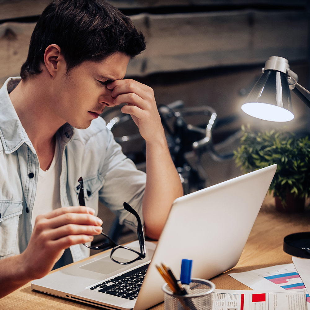 Man dealing with eyestrain at work