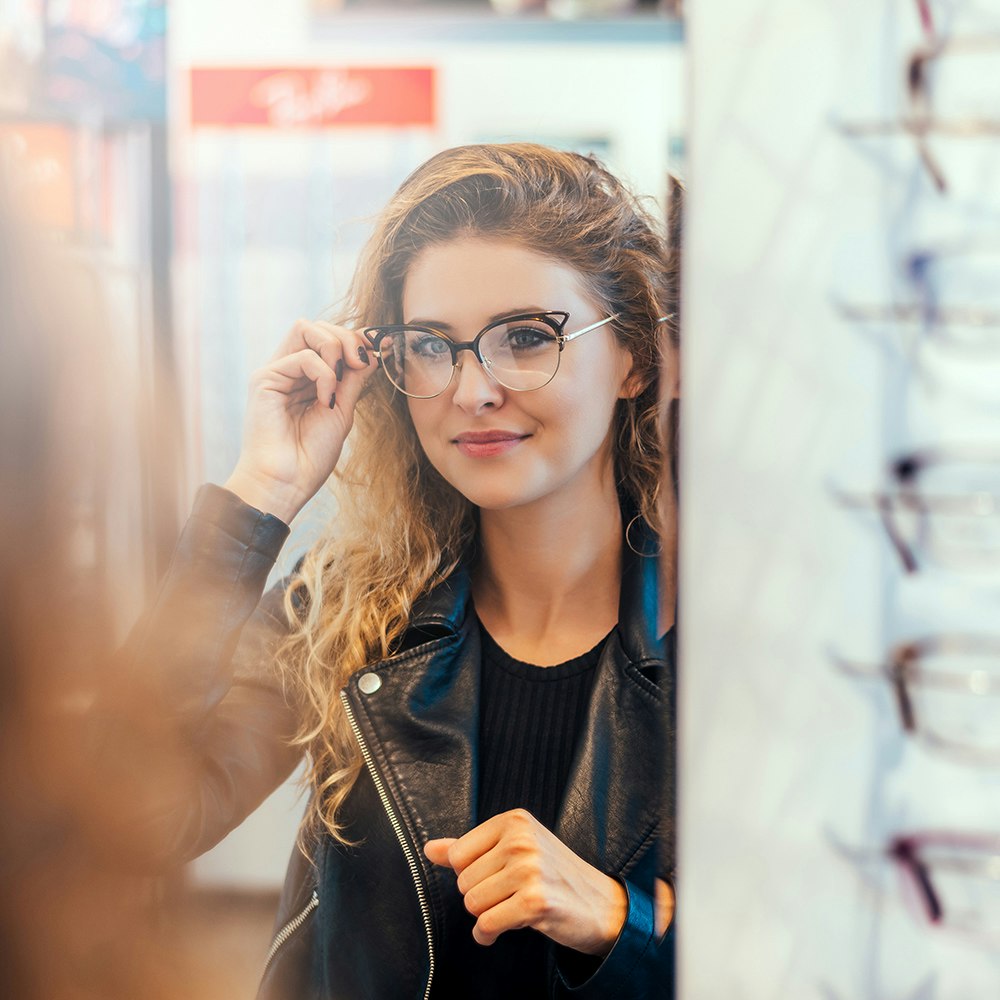 a woman trying on a pair of glasses