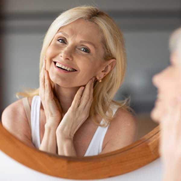 Mature woman smiling in mirror