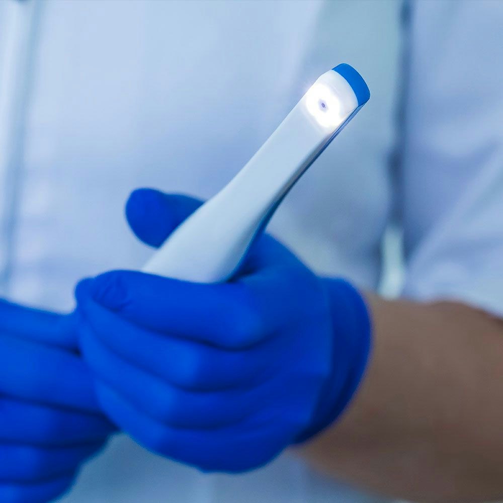 Dentist holding an intraoral camera